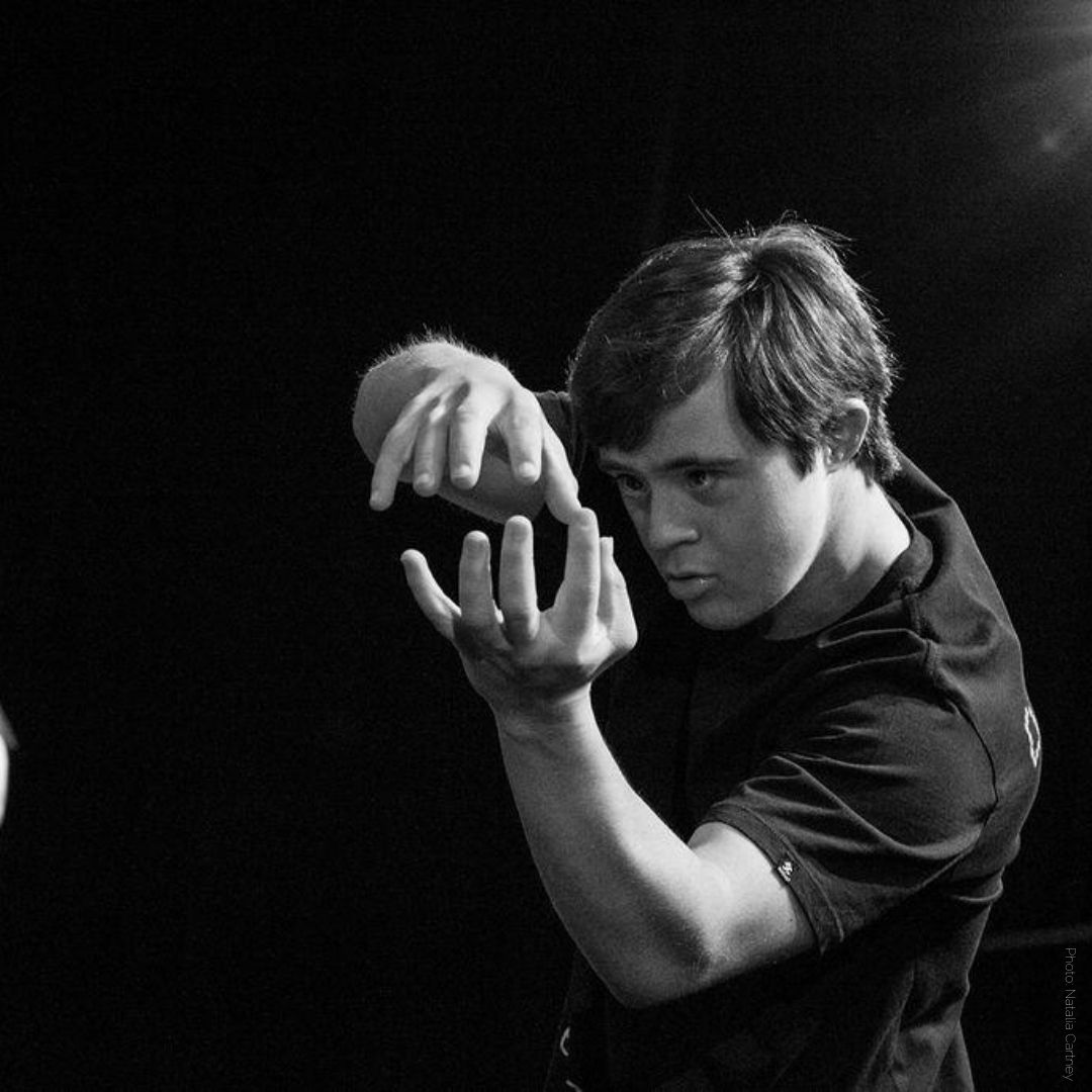 two dancers arms reaching up 